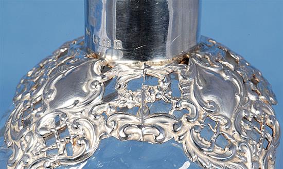 A pair of Edwardian silver mounted waisted glass decanter and stoppers,